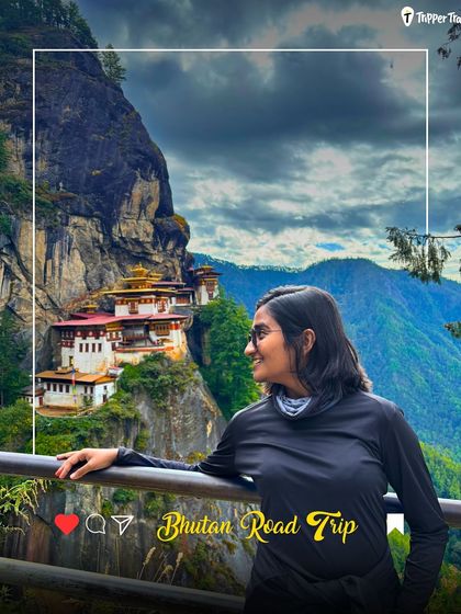 A woman looks at the iconic Tiger's Nest Monastery in Bhutan. This is a bucket-list moment, and my trips are designed to help you experience this spiritual and architectural wonder.