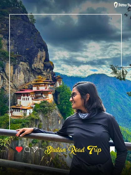 A woman looks at the iconic Tiger's Nest Monastery in Bhutan. This is a bucket-list moment, and my trips are designed to help you experience this spiritual and architectural wonder.