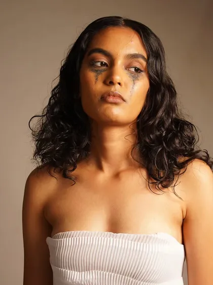 This shot captures a sense of melancholy, with the makeup playing a key role in the storytelling.