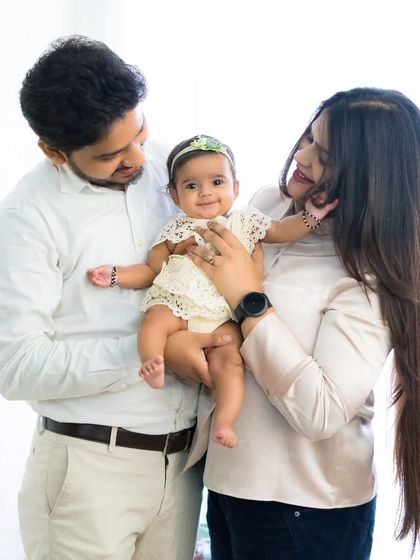 A beautiful family of three. The love and adoration in their eyes as they look at their baby girl is what makes these family portraits so special.