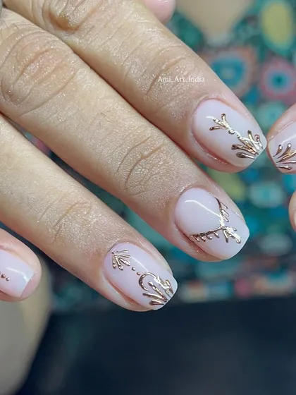 Elegant and minimal gold chrome details on a soft, milky white base.