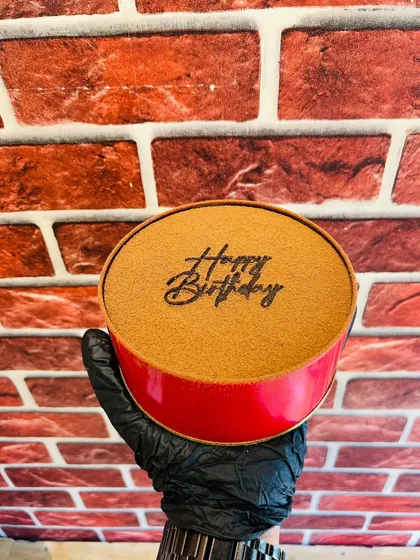 A unique "pull-up" style cake where a message or design is revealed as you pull the tab. This one has "Happy Birthday" written on top.