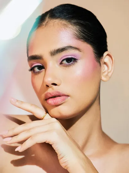 A beautiful shot where the focus is on the soft, pastel-toned eye makeup. The colors are blended seamlessly for an ethereal, watercolor effect.