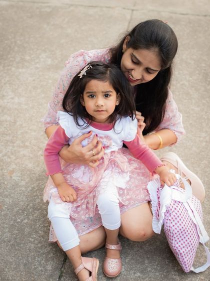 A candid moment between a mother and her daughter. The genuine smiles and relaxed poses create an authentic and heartwarming portrait.