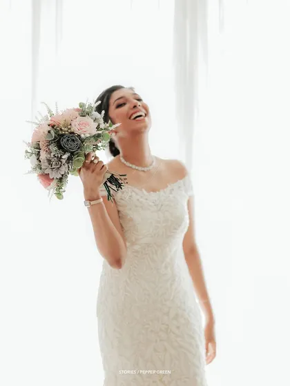 Another shot of pure, uninhibited joy, as the bride laughs heartily, her happiness radiating from the image.