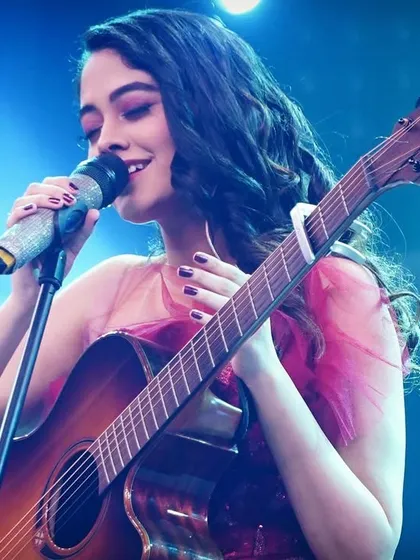 A close-up of me singing on stage. You can see the passion I have for music in my expression, and I bring that same dedication to your custom song.