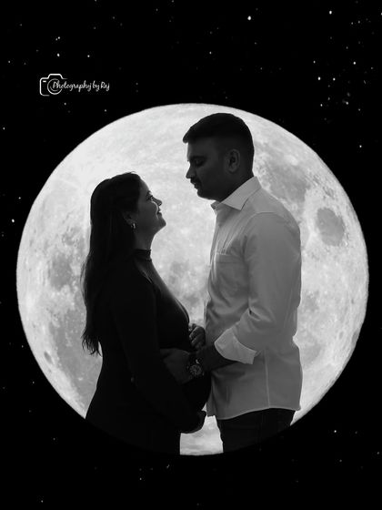 A beautiful silhouette of a couple against a full moon backdrop, capturing their love and anticipation.