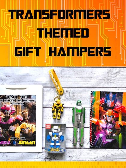 This Transformers-themed gift hamper includes a personalized paper bag, a notebook, a transforming pen, a robot eraser, and a keychain.