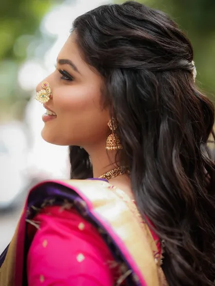 A side profile showcasing the elegant hairstyle and the beautiful 'nath'. The makeup is kept subtle to let the traditional accessories shine.