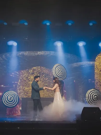 The couple's dance, set against a backdrop of swirling patterns and dramatic smoke effects. We use props and lighting to enhance the choreography and storytelling.