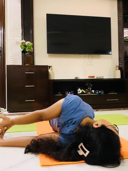 A deep supine twist, showing the student's spinal mobility and ability to relax into a pose.