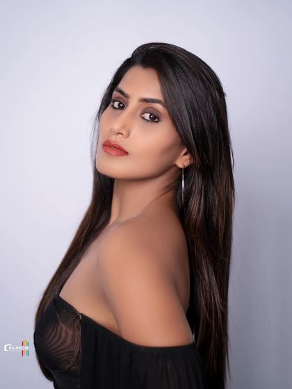 A duplicate of 123, a modern and edgy studio portrait in a sheer black dress.