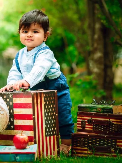 Ready for school, or just an adventure. This outdoor setup with vintage suitcases and a globe is perfect for a back-to-school or traveler theme.