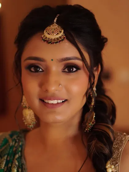 Nony's beautiful smile completes her Mehendi look. The makeup is warm and earthy, designed to enhance her natural features and complement the traditional feel of the ceremony.