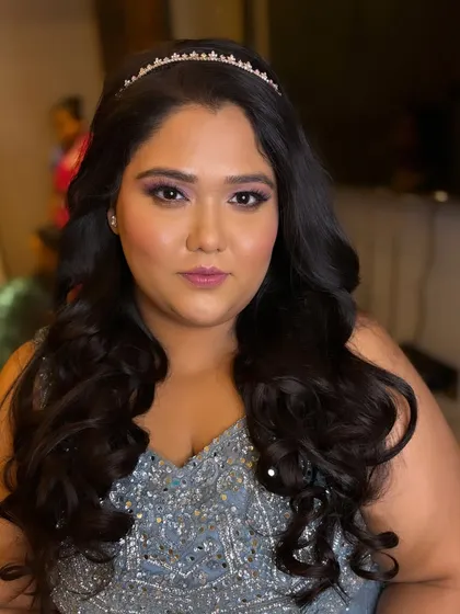 A close-up of the princess look. The glowing makeup, beautiful curls, and sparkling tiara come together to create a look that is both cute and incredibly glamorous.