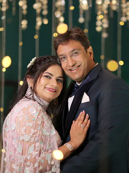 A client celebrating his 25th wedding anniversary in a deep blue ceremonial tuxedo. Every stitch is crafted with love, proving that handmade craftsmanship is perfect for celebrating any milestone.