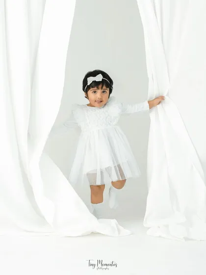 Peek-a-boo! A child's portrait session should be as playful as they are. Using simple props like these white curtains, I create a fun environment for your little one's personality to emerge naturally.