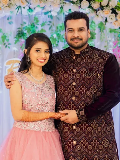 A classic portrait of the couple after their outfit change at the engagement party. They look elegant and happy together.