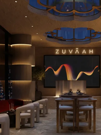 A large screen adds a modern touch to the textured, layered environment of Zuvaah. The design balances entertainment with an immersive, thoughtfully crafted atmosphere.