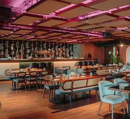 This wide view of a resto-bar in Hennur showcases my approach to hospitality design. I created a dynamic atmosphere with varied seating zones, dramatic ceiling acoustics, and a prominent bar, perfect for both intimate dinners and lively social gatherings.