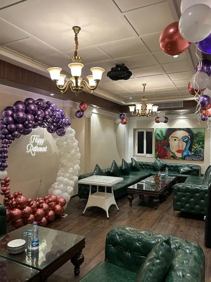 A wide shot of the retirement party, showing how the balloon decor becomes the focal point of the room.