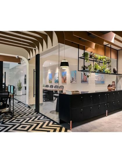We designed this locker and storage area to be both functional and stylish, with a suspended metal planter shelf that adds a touch of greenery and visual interest.