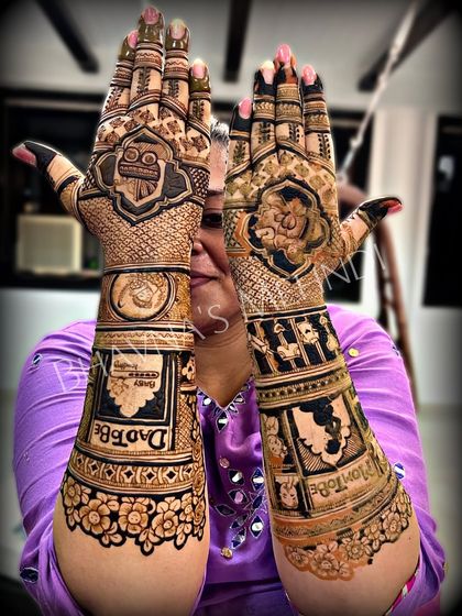 A special design for a special journey. This baby shower mehndi celebrates the mom to be with cute motifs like a baby in a cradle and "Mom to be" and "Dad to be" written on the arms.
