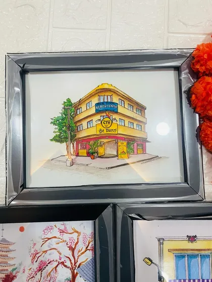 A beautiful watercolor style illustration of a building, housed in a sleek grey frame. This shows that I can also create architectural or landscape illustrations for a different kind of decor.