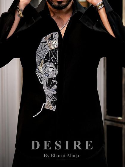 Adjusting the cuffs on a piece of art. This shirt is designed to be a statement from every angle, with details that capture the eye and spark conversation.