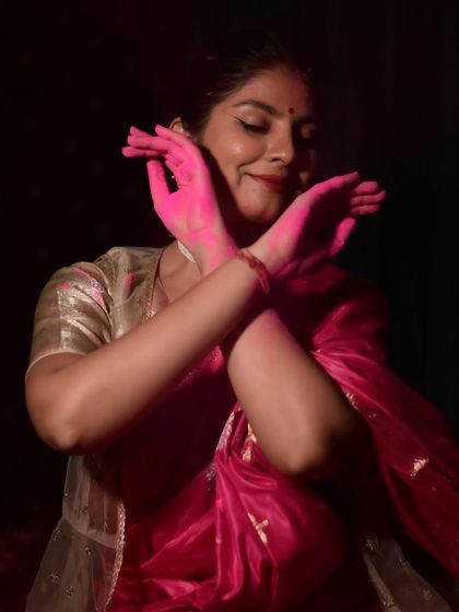 A portrait capturing a smile through a veil of pink Holi color. This photo expresses the joy and mystique of the festival.