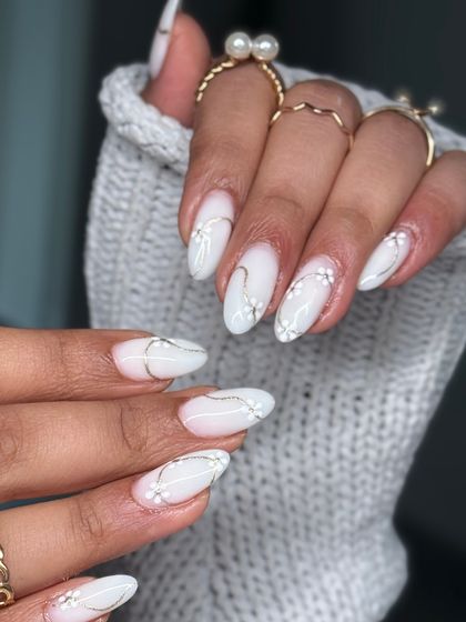 A delicate and elegant design featuring a milky white base with hand-painted fine silver lines and tiny white flowers. Perfect for a bridal or special occasion look.