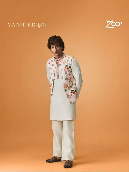 A full view of the floral embroidered jacket paired with a simple kurta. This design from the Vanderphool collection is perfect for adding a touch of elegance to your festive wardrobe.