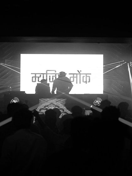 A powerful black and white shot from Ginza with my name in Hindi on the screen. The stark lighting creates a dramatic, iconic look.