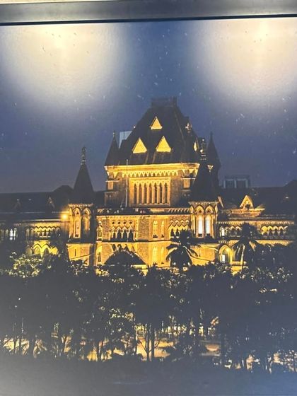 The Bombay High Court illuminated at night. The pursuit of justice is a round-the-clock commitment.