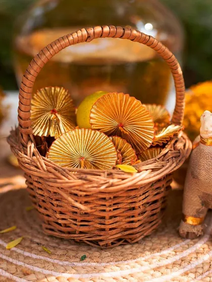Small details for the Haldi, including a wicker basket with gota patti fans and miniature jute camels, adding a touch of Rajasthani-inspired craft.