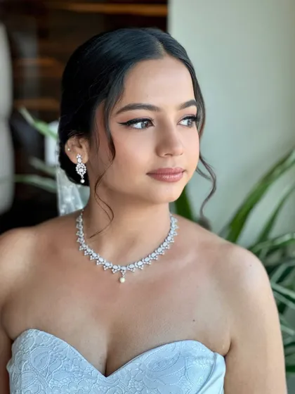 The soft, natural light enhances Beracah's radiant complexion. Her makeup feels light and breathable, allowing her natural beauty to shine through on her special day.