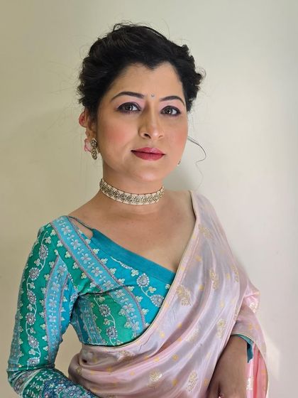 A classic portrait. The makeup is subtle yet defining, with a focus on clean lines and a soft lip color.