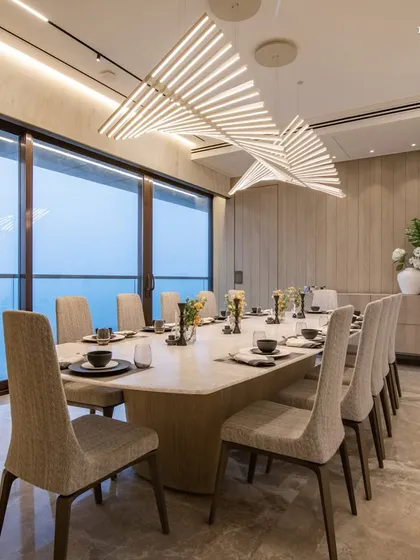 A full view of the seaside dining room, where the long table is perfectly positioned to take in the panoramic views of the Arabian Sea. The room's ambient lighting and refined decor create an inviting atmosphere that complements the gourmet experience.