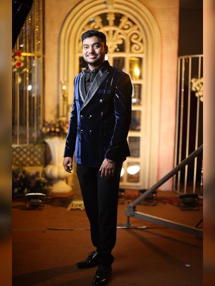 This client chose a double-breasted blue velvet tuxedo for his reception. The modern design and luxurious fabric make it a standout choice.