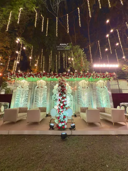 The full expanse of the Nikah decor, with hanging lights, floral runners, and multiple seating areas creating a cohesive and festive environment.