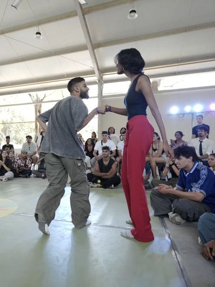 A moment of connection between two dancers during a battle at Spectra. It's an exchange of energy, skill, and respect.