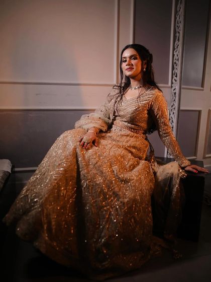 My engagement bride Silky in a gorgeous golden lehenga. The dramatic lighting highlights her elegant and regal look.
