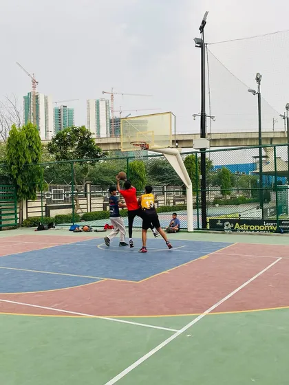 A contested layup attempt, showing the grit and determination we foster in our players.