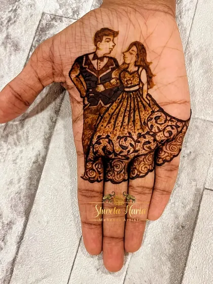 A minimalist yet elegant engagement design. This artwork focuses on the palm, featuring a beautifully detailed portrait of the couple in western attire, with the bride's flowing gown created from delicate henna patterns.