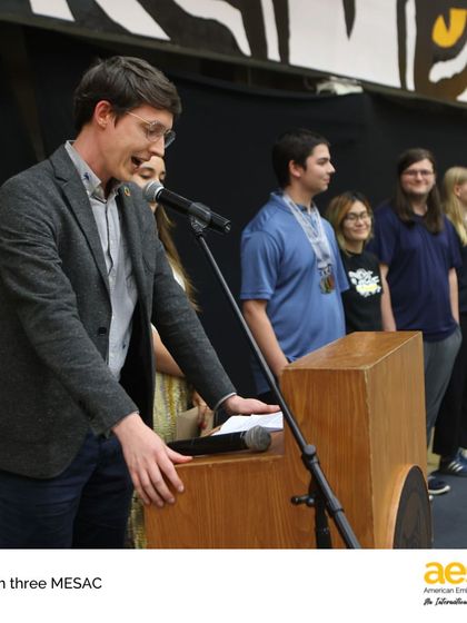 A coach from our Speech & Debate team addresses his students during the Season Three MESAC awards. Our activities extend to academic competitions, where students hone their public speaking and critical thinking skills.