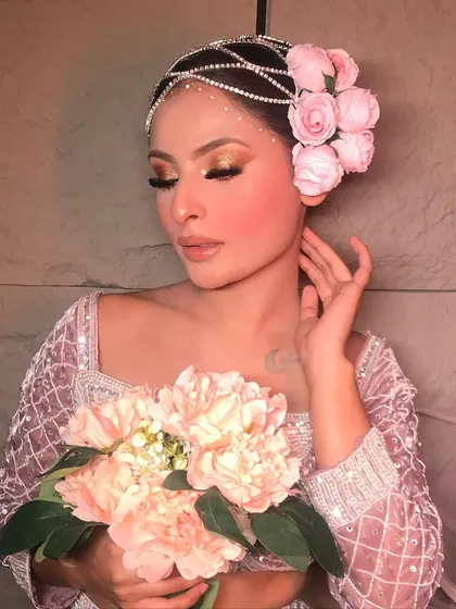 A beautiful "Rose" themed look, featuring soft pink tones and a stunning floral hair accessory. This is a perfect example of a romantic, soft glam style.
