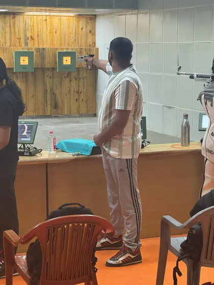 An adult shooter takes aim during a practice session. My coaching is open to all age groups, from young children to senior citizens who are passionate about the sport.