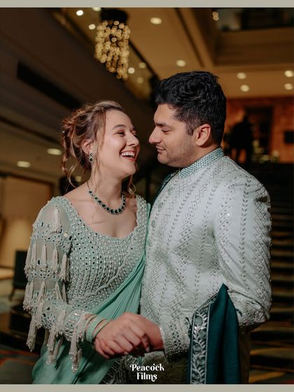 A beautiful moment from a fusion cocktail evening. The couple shares a laugh, showcasing a seamless blend of cultures and a chemistry that lights up the room.