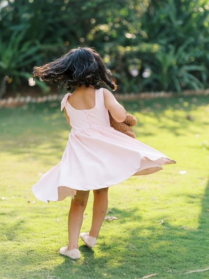 A little girl twirling in her pink dress. Capturing movement and the simple joy of being a child is what it's all about.