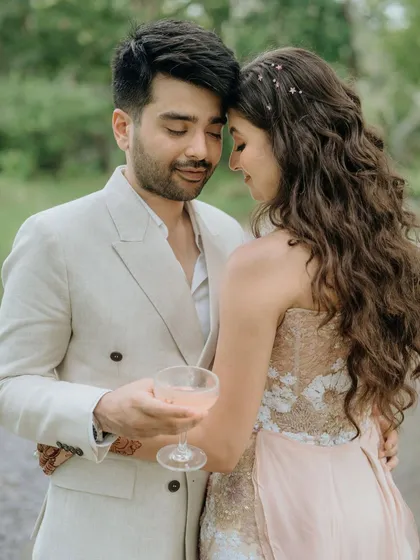 An intimate and tender moment between the couple during their daytime celebration. The focus is on their close connection, sharing a quiet moment together with a glass of champagne.